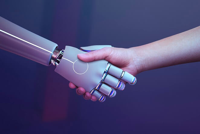 Um robô dando a mão a uma pessoa.